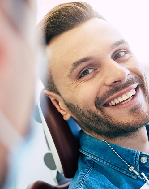 Man with straight teeth smiling at dentist