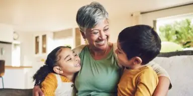 Older woman hugging her grandkids