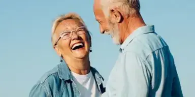 Senior man and woman laughing outside